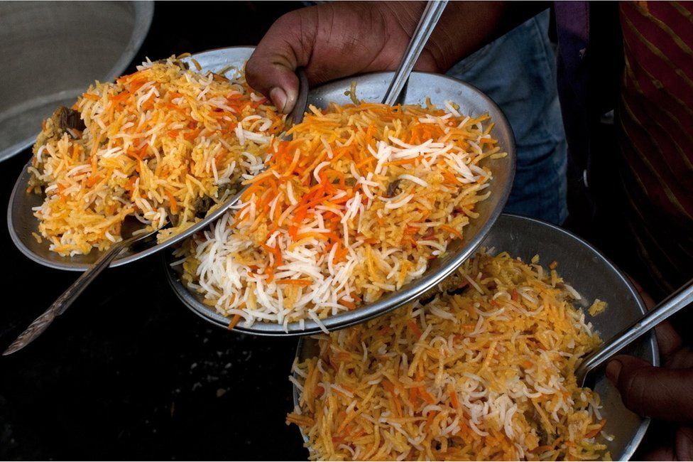 Plates of mutton biryani are served at an outside eatery in Lucknow on November 22, 2014. Biryani is a South Asian dish made with rice, spices and meat or vegetables