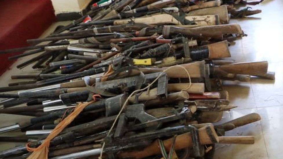 Members of the Yansakai vigilante group sit inside an auditorium at the Zamfara State Government house as their members surrendered more than 500 guns to the Zamfara State Governor, Bello Matawalle, as part of efforts to accept the peace process of the state government in Gusau, on December 3, 2019.