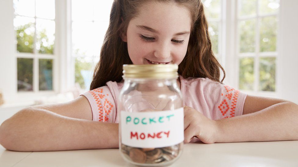 Girl saving her pocket money (posed by model)