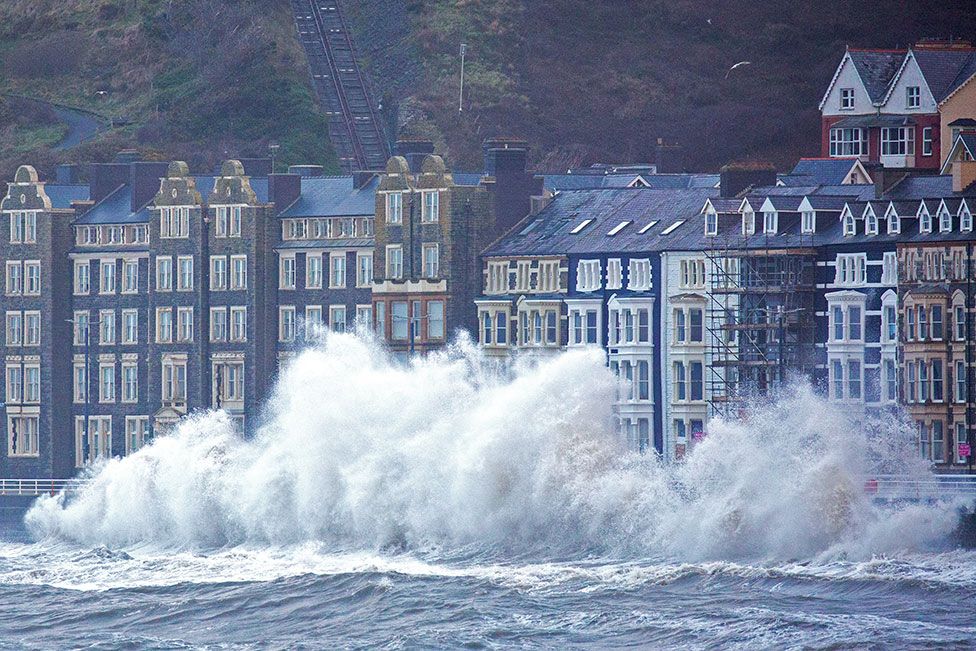 Storm Eunice and rough seas bring huge crashing waves along Aberystwyth promenade in Ceredigion, Wales