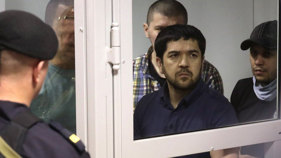 Umar Khasanov (C) and other gang members in court
