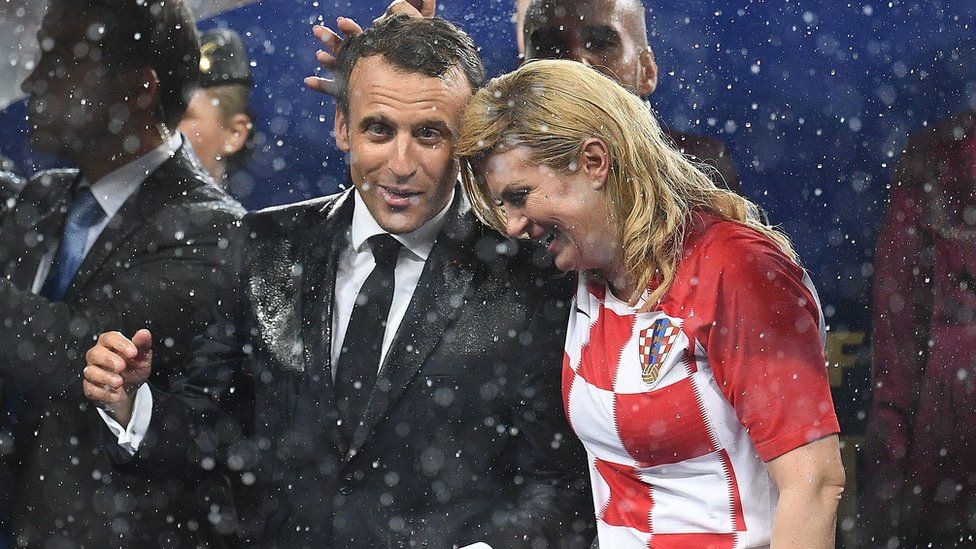 French President Emmanuel Macron (left) talks with Croatian President Kolinda Grabar-Kitarovic during the trophy ceremony at the end of the Russia 2018 World Cup final football match between France and Croatia