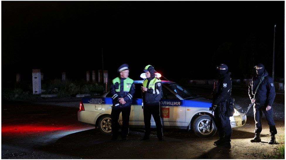 Полицейские дежурят на блокпосте на дороге недалеко от места происшествия после крушения частного самолета, связанного с главарем наемников Вагнера Евгением Пригожиным