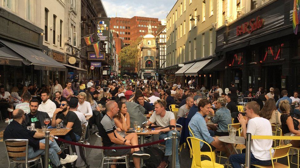 People sit outside restaurants and bars in London's Soho district on Saturday 19 September 2020