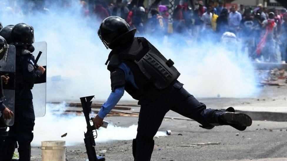 Protesters and riot police clash in Honduras