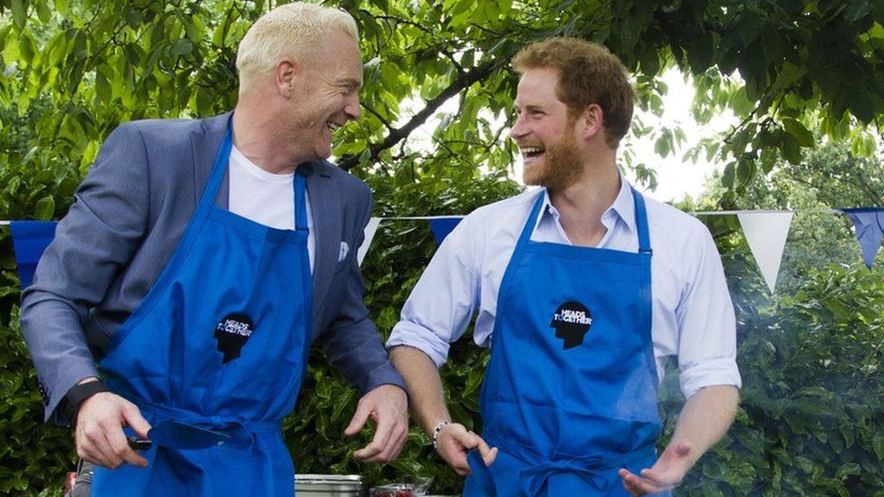 Iwan Thomas and Prince Harry at Heads Together event at Kensington Palace - cooking burgers