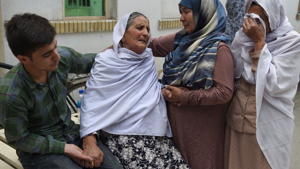Afghan women weep for their relatives at the Isteqlal Hospital after a suicide attack in Kabul, 11 June 2018