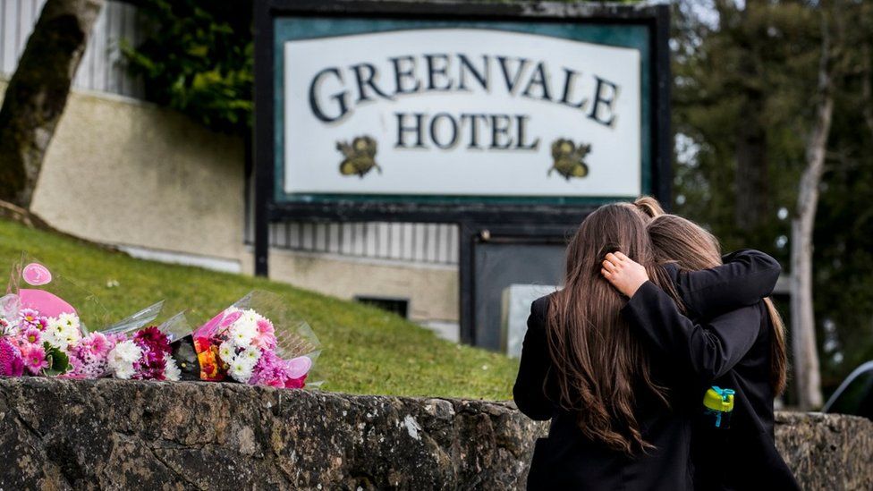 Students from Holy Trinity College leave floral tributes outside The Greenvale Hotel in Cookstown, 19 March 2019