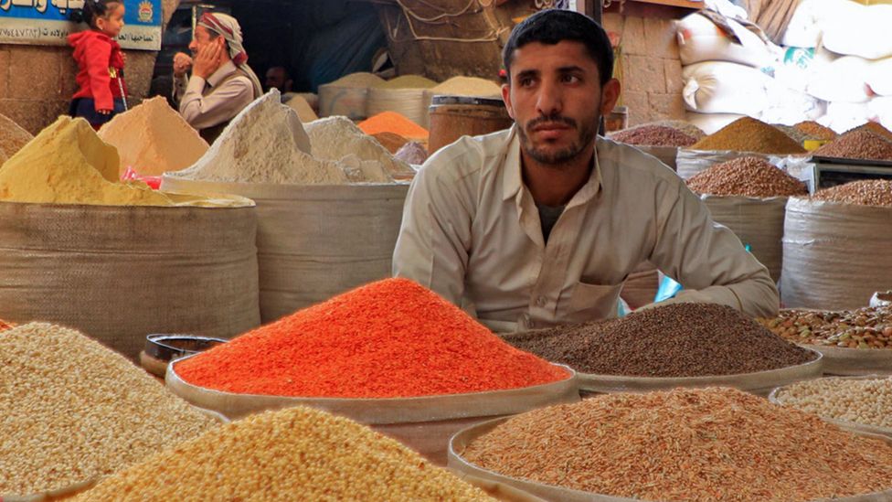 A vendor waits for customers at a market in Yemen on 28 February 2022