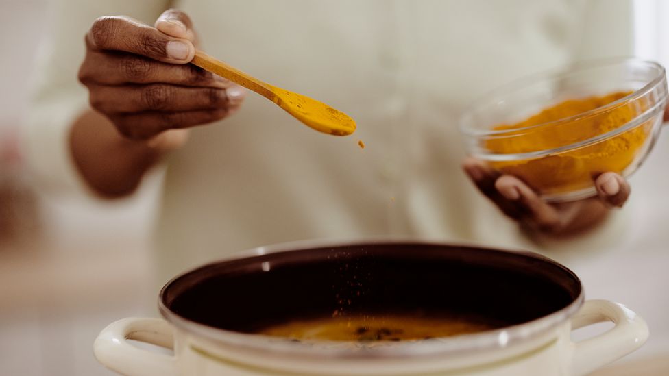 person cooking curry