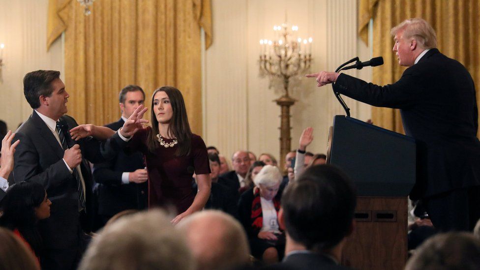 President Donald Trump, journalist Jim Acosta and a White House intern