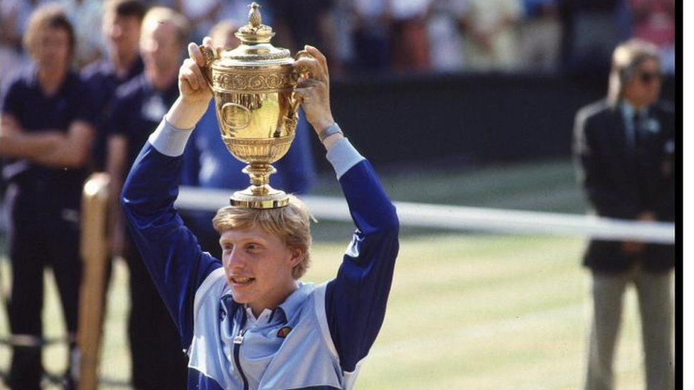 Boris Becker, at seventeen (the youngest ever mens winner), holds aloft the Mens Singles trophy at Wimbledon.