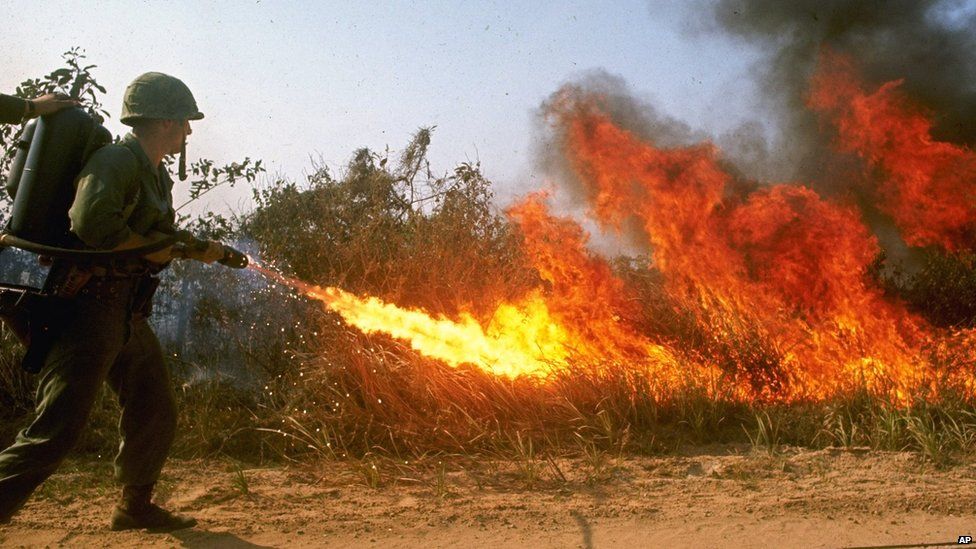 An American soldier demonstrates a flamethrower Circa 1965 in South Vietnam .