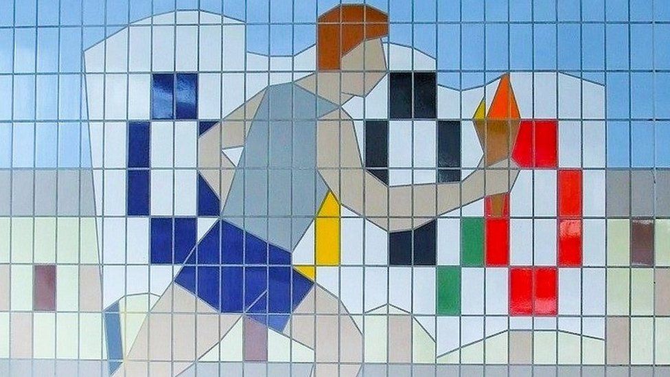 Tile mural of athlete carrying Olympic torch