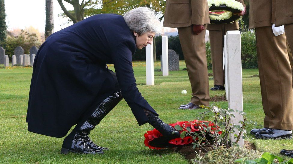 Theresa May lays a wreath at the grave of John Parr