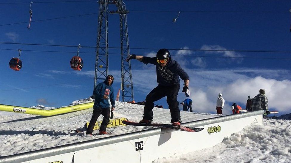Owen Pick snowboarding on a rail