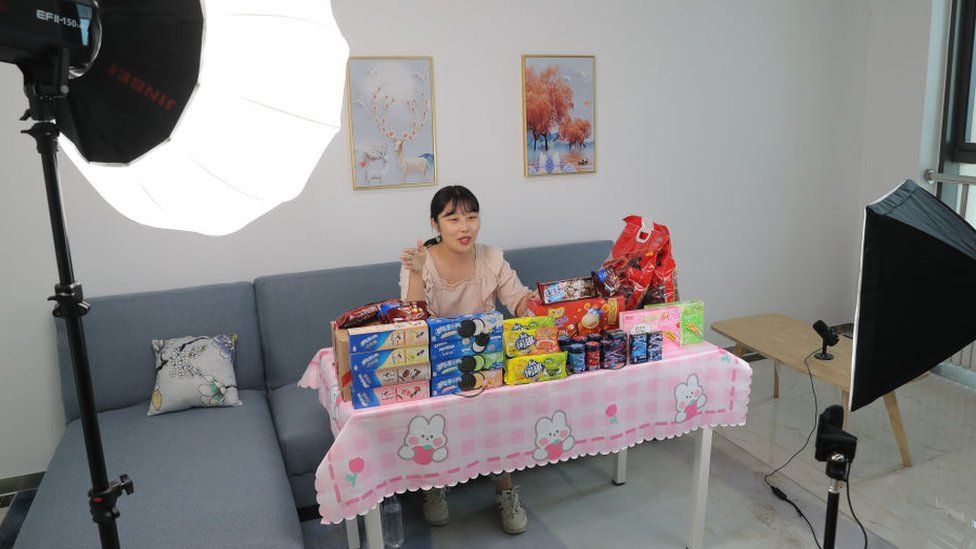 A livestreamer sells biscuits via live streaming in Tianjin, China