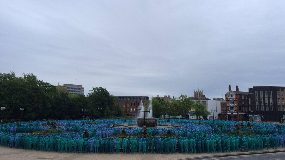 Naked people painted blue standing in Queens Gardens