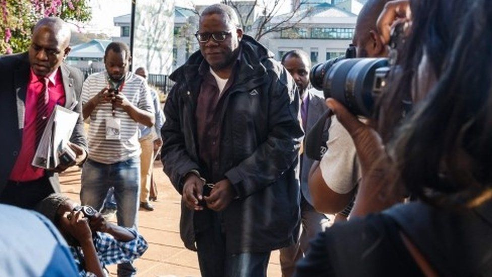 Zimbabwe leading opposition figures Tendai Biti of Zimbabwe's main opposition Movement for Democratic Change arrives in handcuffs at the Harare Magistrates court August 9, 2018.