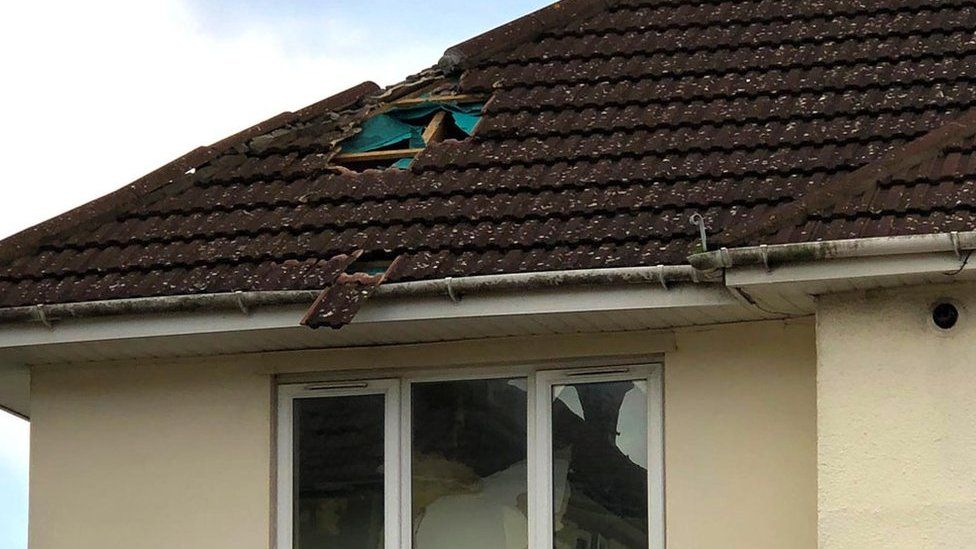 Roof of house with hole in it