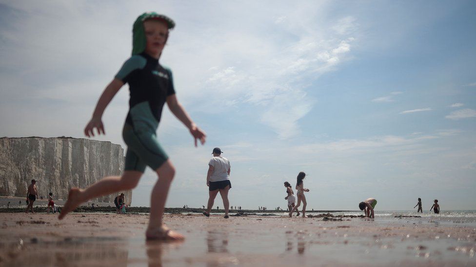 Children enjoy the weather during a hot day near the Seven Sisters Cliffs, at Birling Gap, in East Sussex