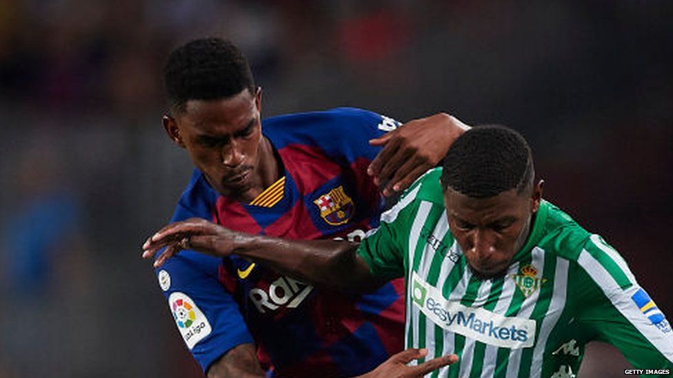 Barcelona defender Junior Firpo battling for the ball with Real Betis right-back Emerson
