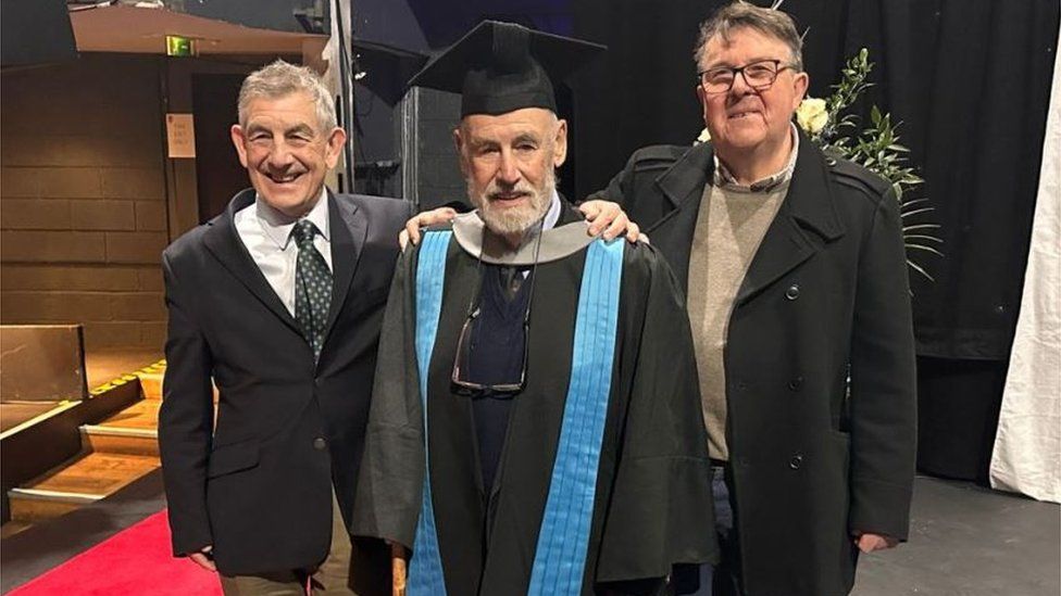 Dr David Marjot (centre) with his son and son-in-law at graduation ceremony at Kingston University