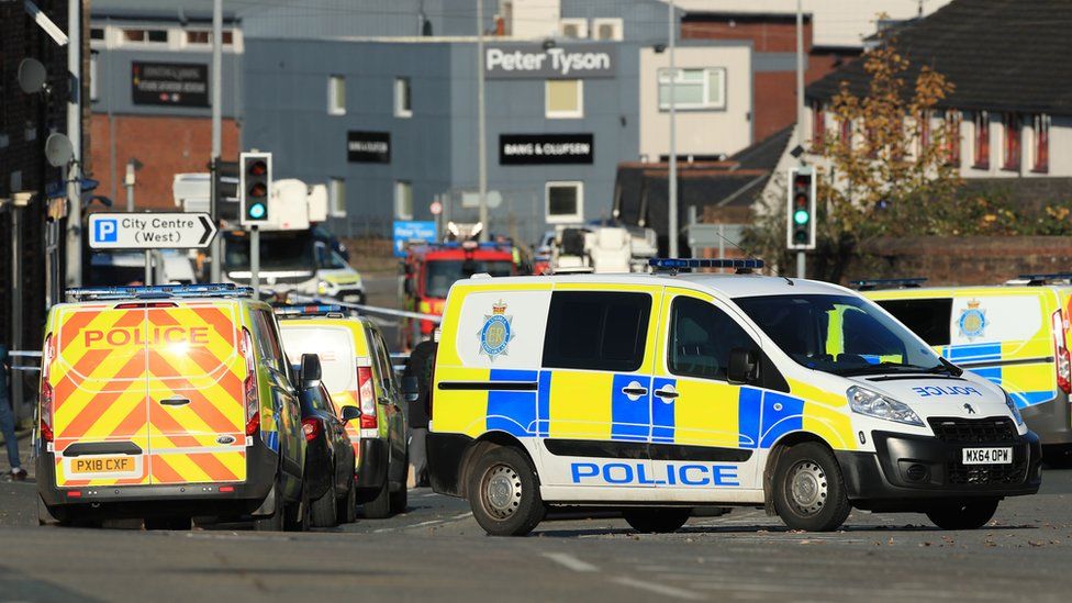 Police vehicles parked near Dixons Chimney