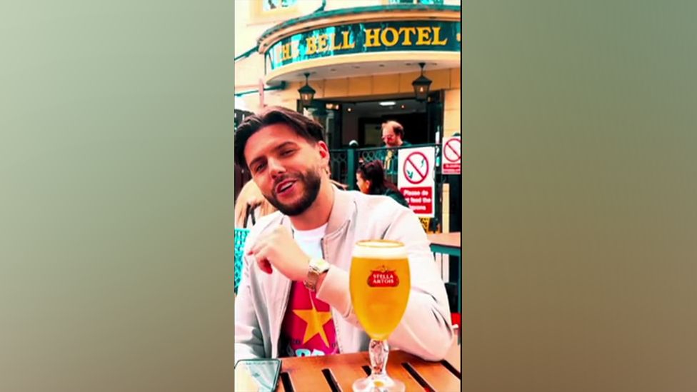 Leon Mallet sitting down with a beer outside a pub in Norwich