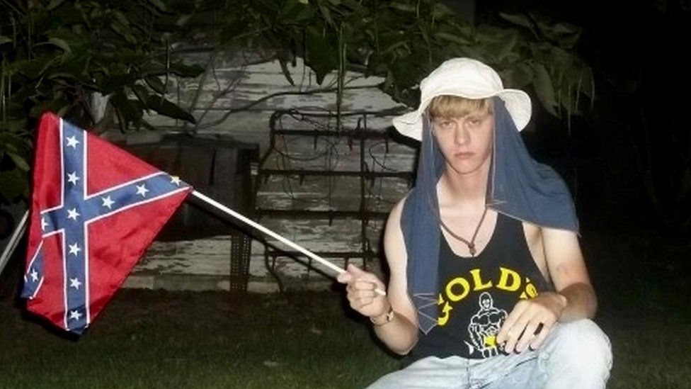 Dylann Roof posing with a Confederate flag
