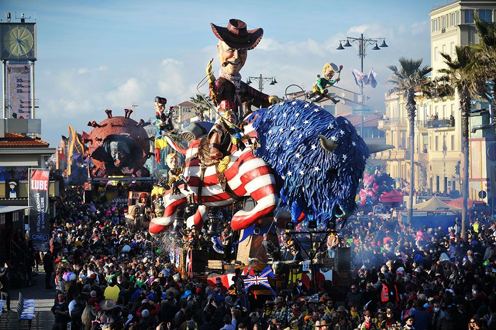 A giant papier mache float representing the US President Joe Biden called Buffalo Biden, moves through the streets of Viareggio, Italy, during the traditional Carnival of Viareggio parade on 20 February 2022