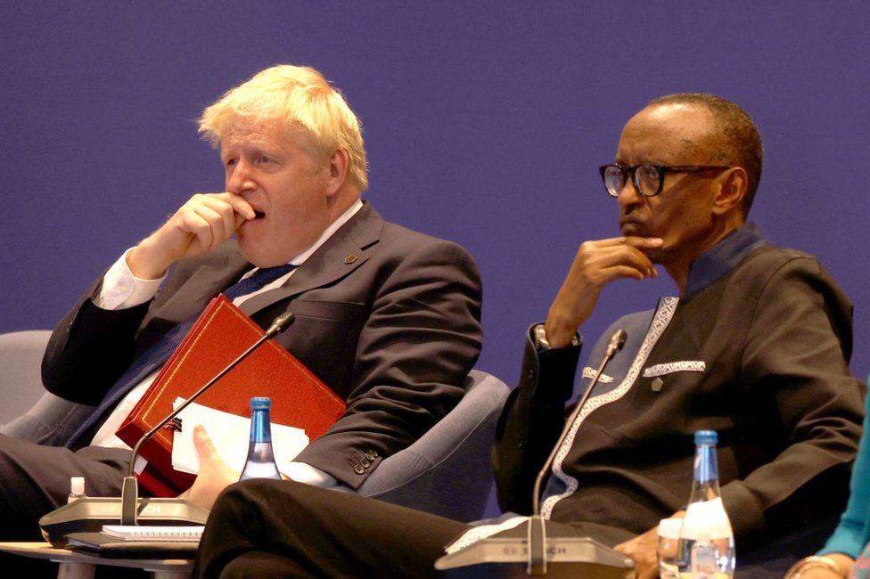 Britain's Prime Minister Boris Johnson yawns as he sits alongside Rwanda's President Paul Kagame.