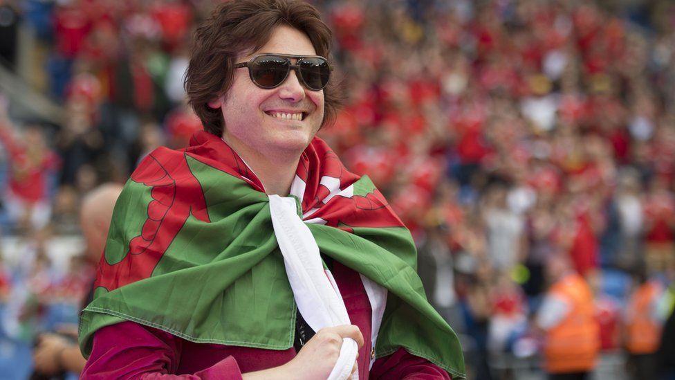 Manic Street Preachers star Nicky Wire wraps himself with a Welsh flag