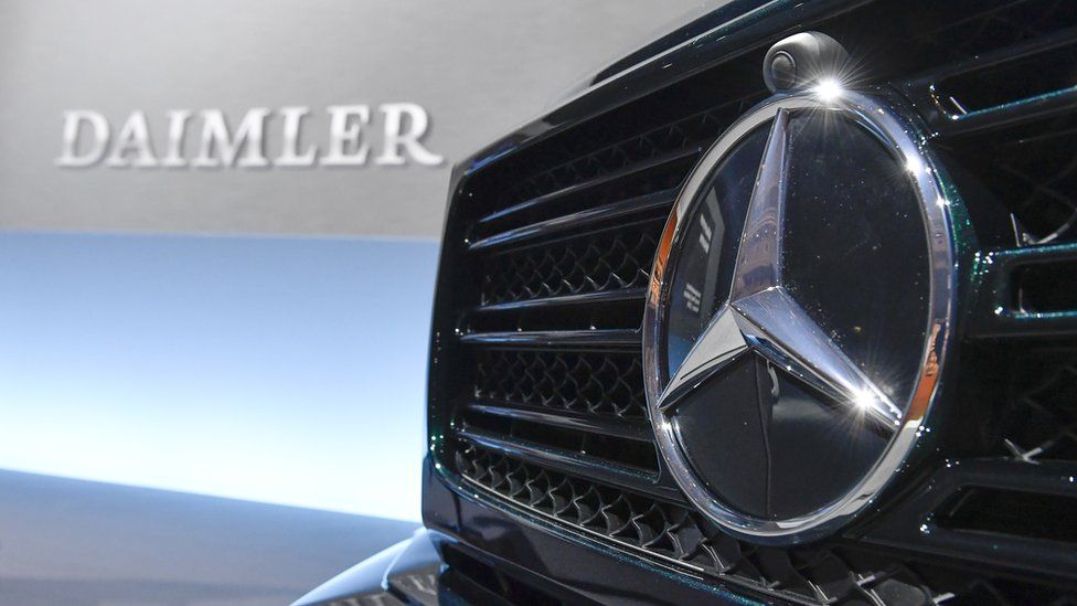 Mercedes-Benz star in front of automobile