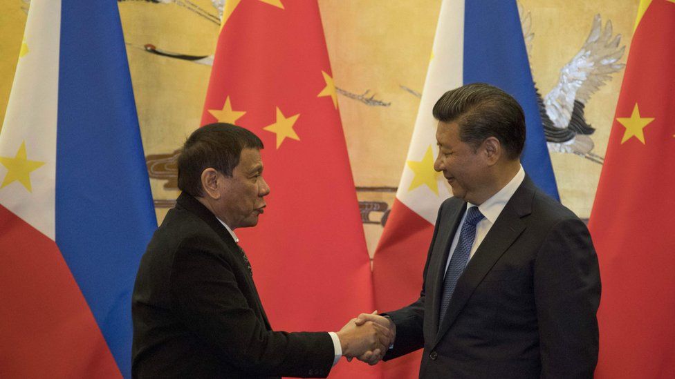 China's President Xi Jinping and Philippines president Rodrigo Duterte shaking hands.