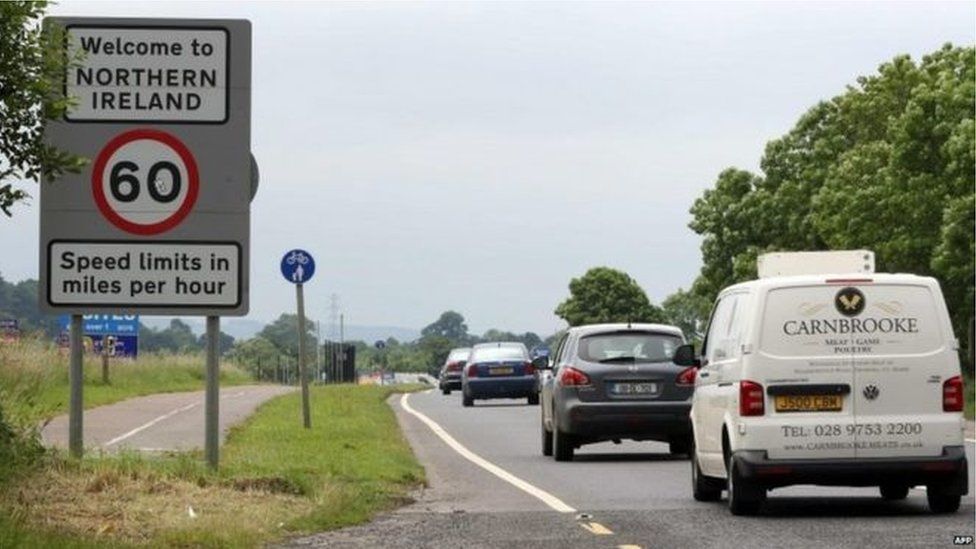 Vehicles travel on a road over the Irish border