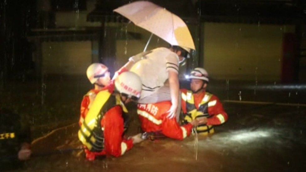 Woman is rescued from her flooded home