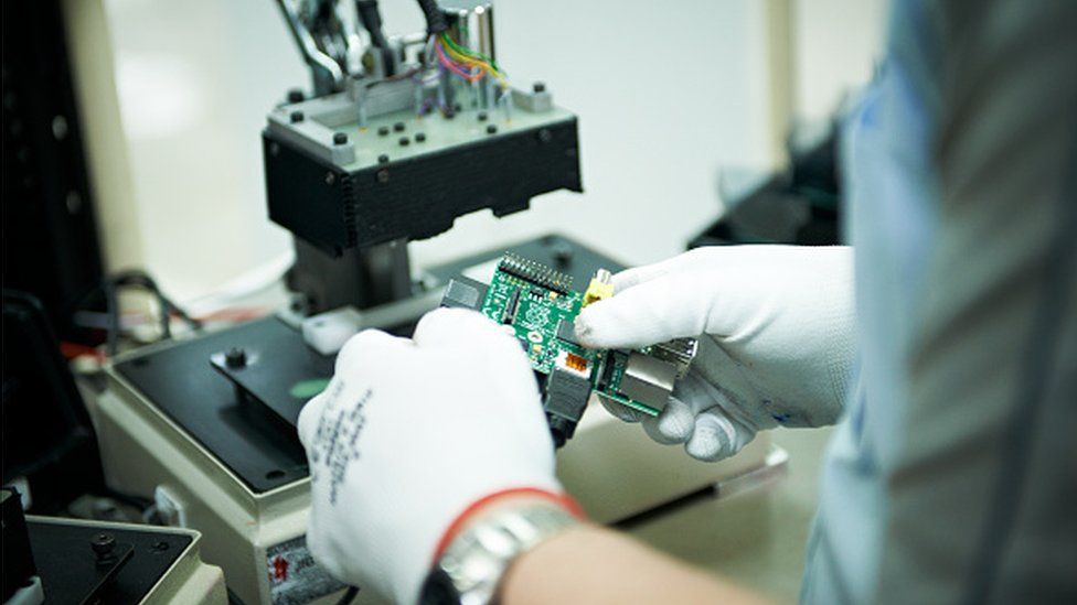 A person holding a circuit board
