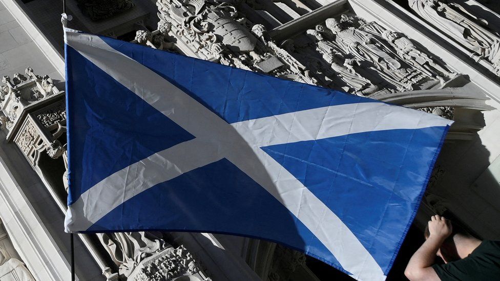 A Scottish Saltire flag is flown as pro-Scottish independence campaigners protest outside of the United Kingdom Supreme Court whilst a case continues to decide whether the Scottish government can hold a second referendum on independence next year without approval from the British parliament, in London,