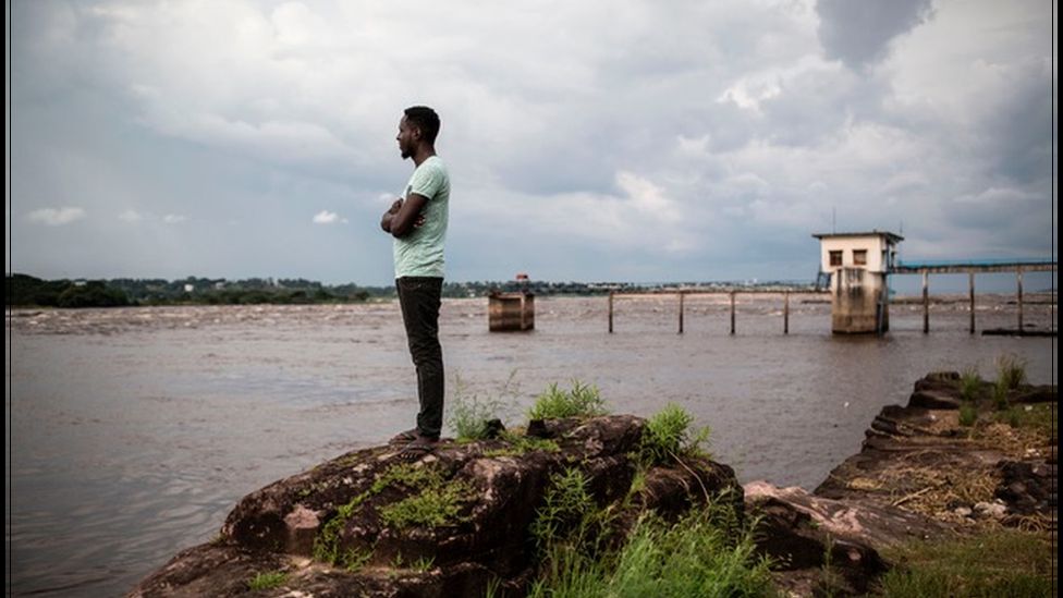 Man staring out at river Congo