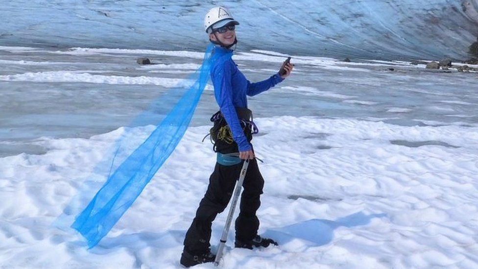 Celeste Labedz wearing a cape in front of a glacier