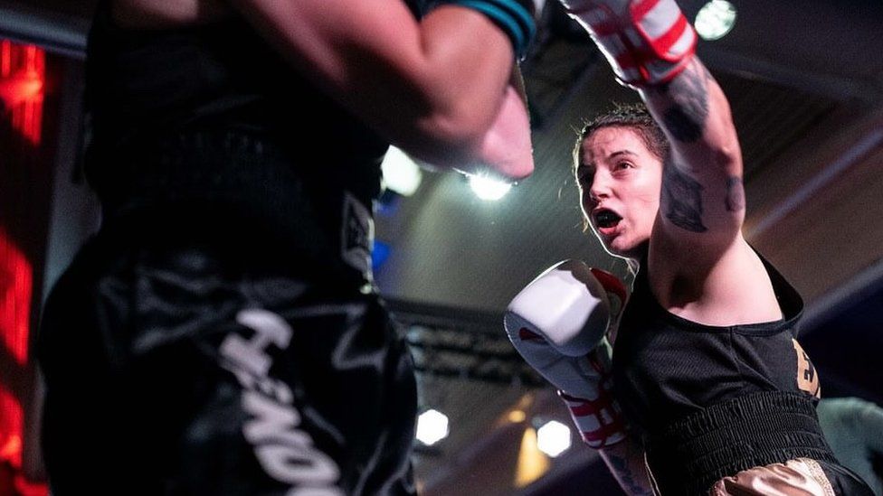 Eilish Tierney in action, wearing a black vest and white gloves