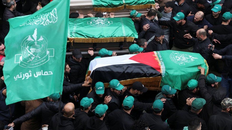 Mourners gather during the funeral of deputy head of Hamas, Saleh al-Arouri