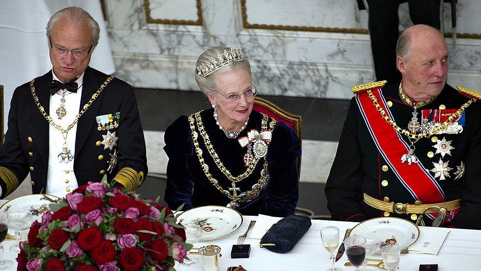 King Carl XVl Gustaf of Sweden, Queen Margrethe ll of Denmark and King Harald V of Norway in their finery, sat a table during a gala dinner