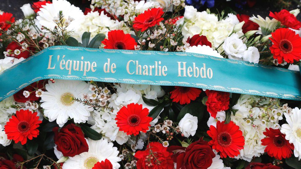 A wreath of flowers outside Charlie Hebdo's former offices in Paris on the fifth anniversary of the attack on the satirical magazine that killed 12 people, 7 January 2020