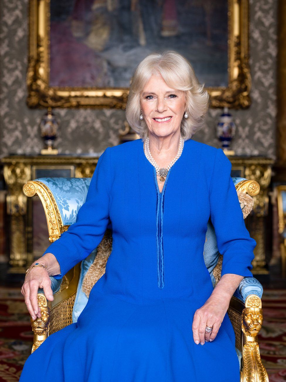The Queen Consort smiles while wearing blue for the new pictures