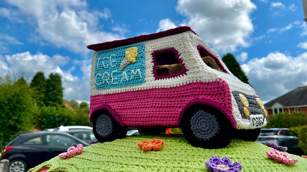 Summer-themed post box topper, featuring crochet ice cream van