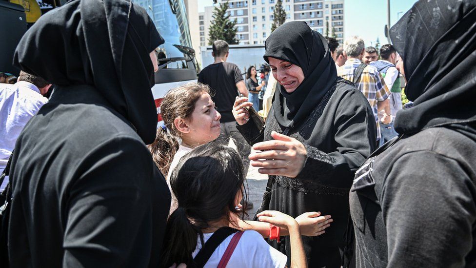 In this file photo taken on August 06, 2019, family and friends say goodbye as Syrian refugee voluntarily board buses returning to neighbouring Syria in the Esenyurt district of Istanbul