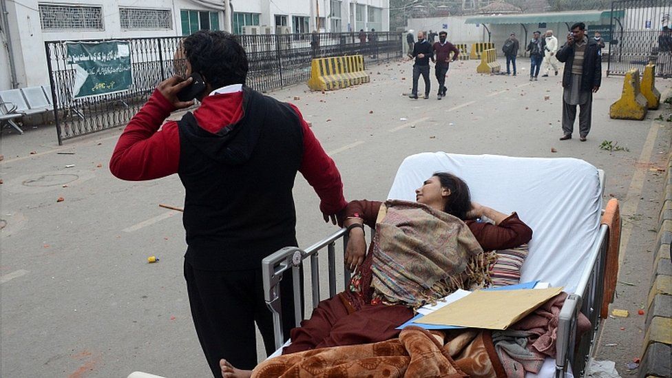 Patients are left outside the Punjab Institute of Cardiology (PIC), after lawyers clashed with police and stormed the hospital in Lahore 11 December 2019