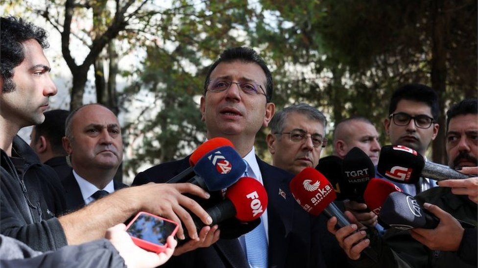 Ekrem Imamoglu speaking to reporters about the case against him